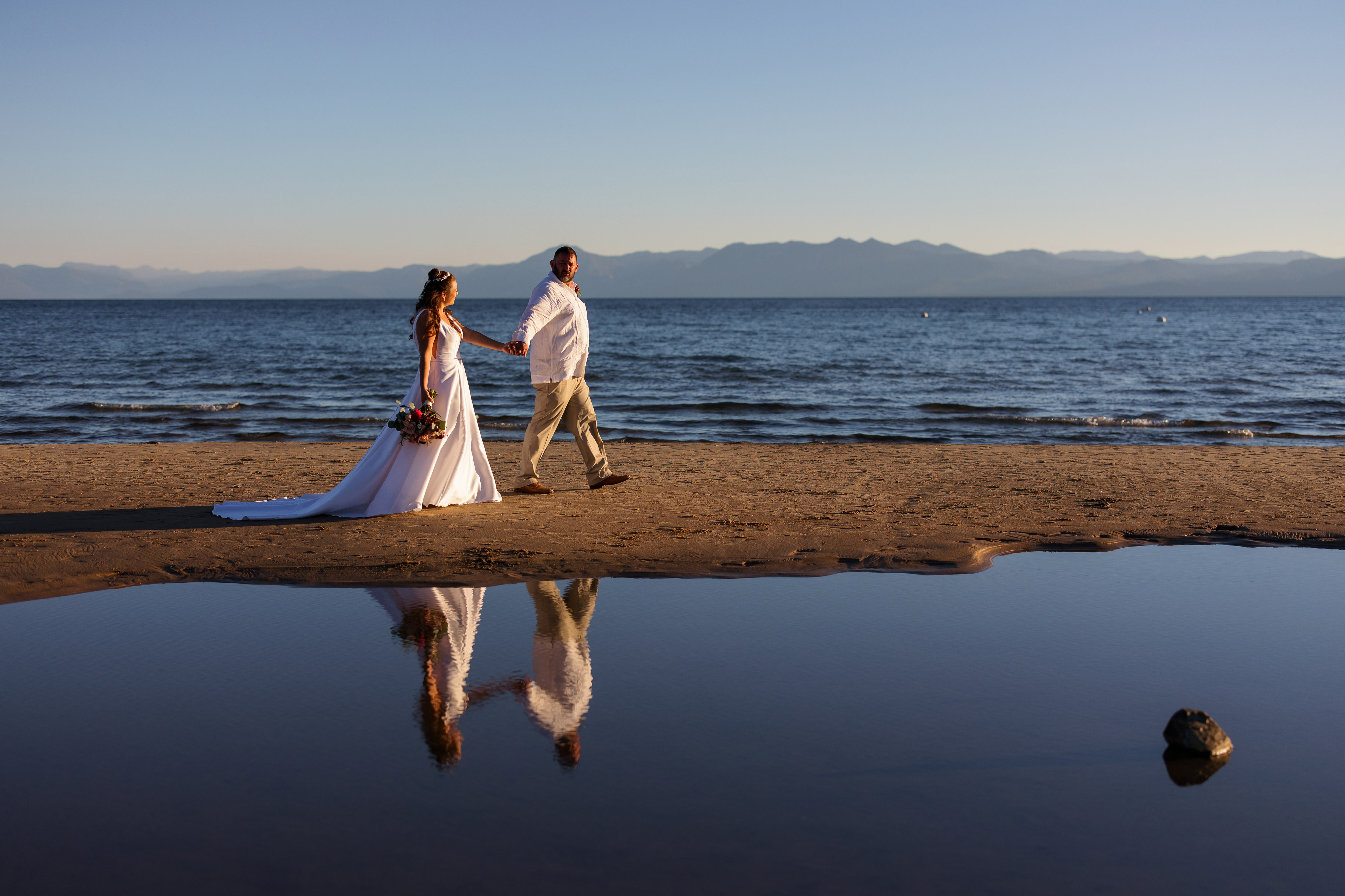 Wedding couple walking on the beach in Kings Beach