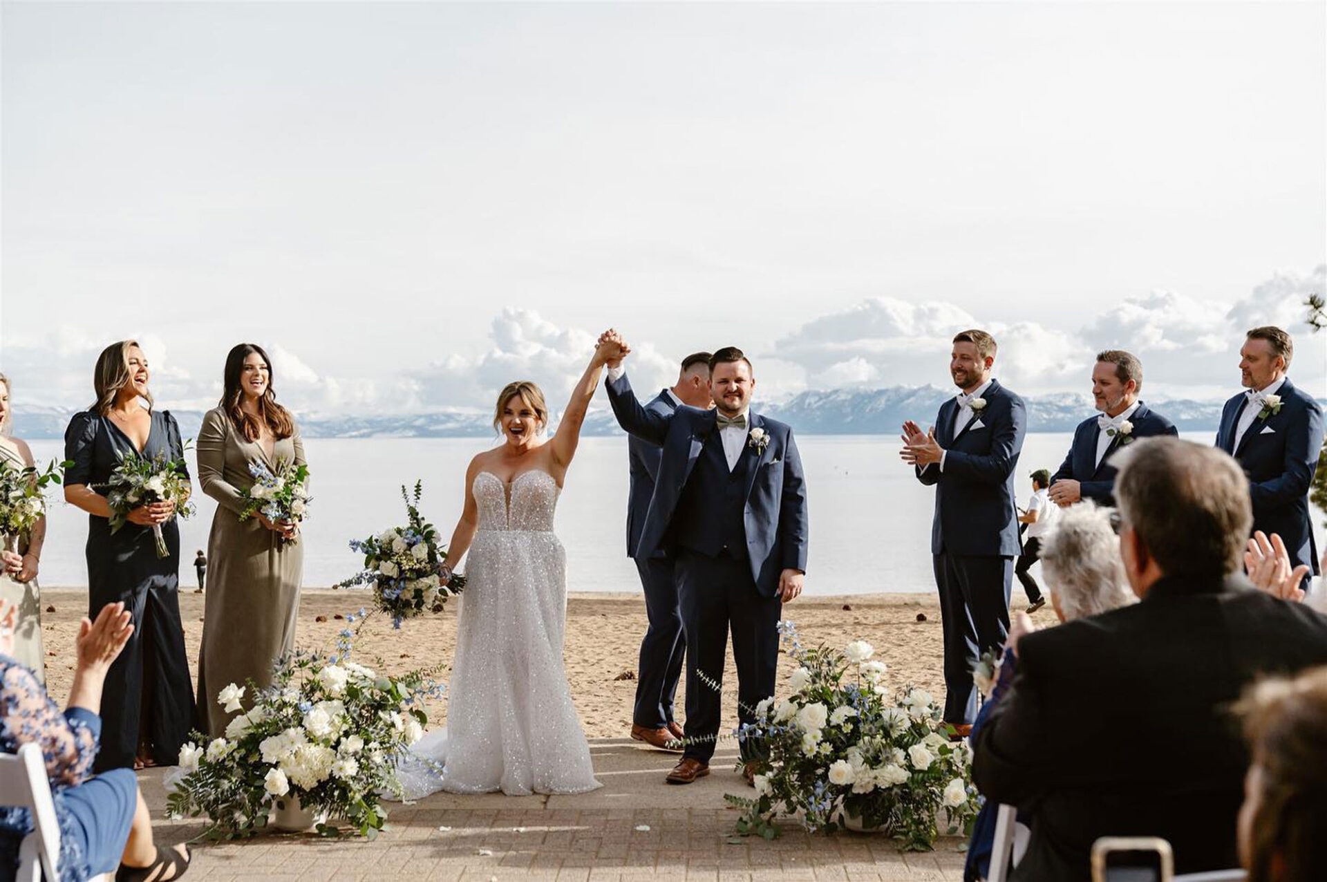 Bride and groom celebrating hand-in-hand after completing ceremony