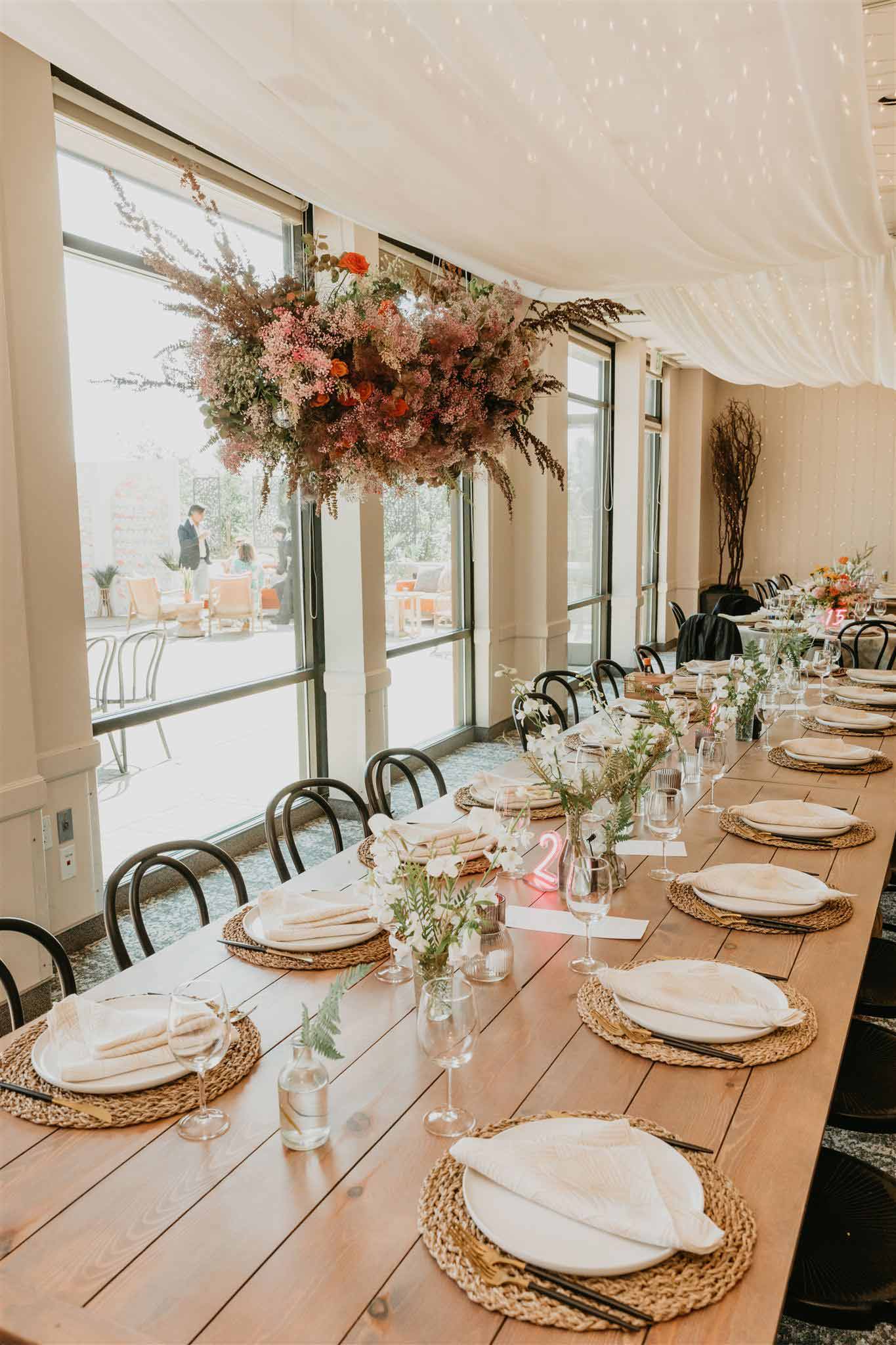 Simple yet elegant wedding dining room setup by windows