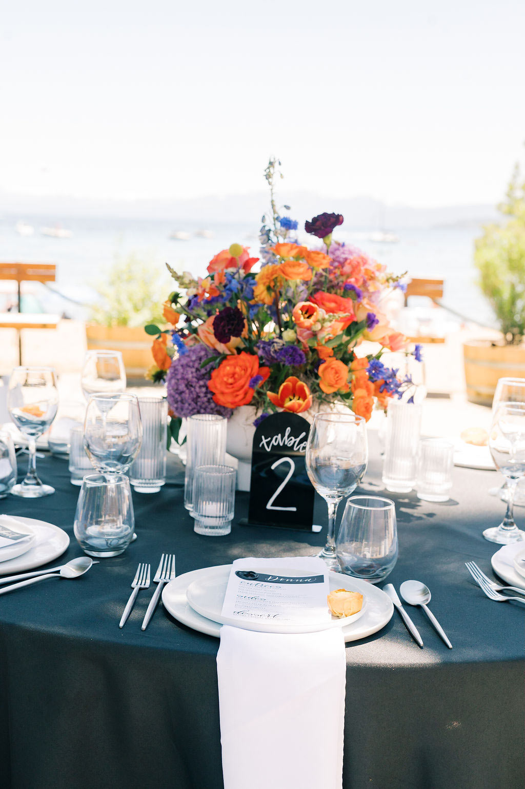 Wedding flower centerpiece and centerpiece with black linen tablecloths