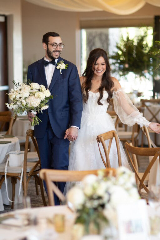 bride and groom walking into dining room