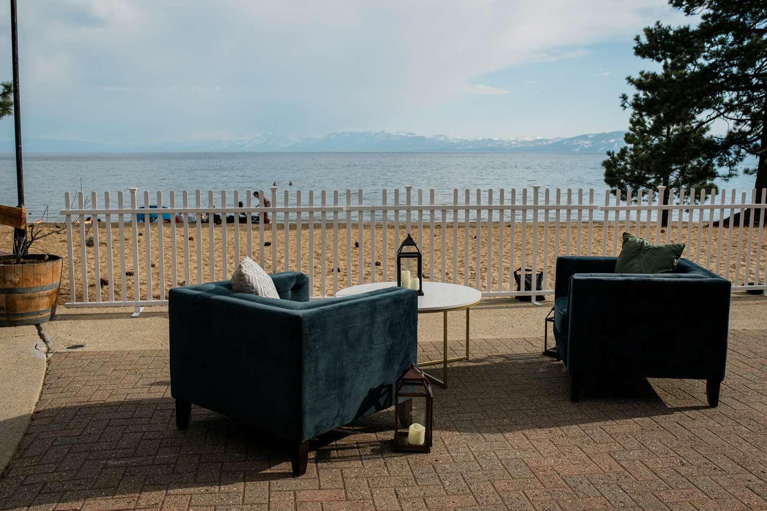 Stylish outdoor lounge area with cozy chairs and a view of Lake Tahoe in the background