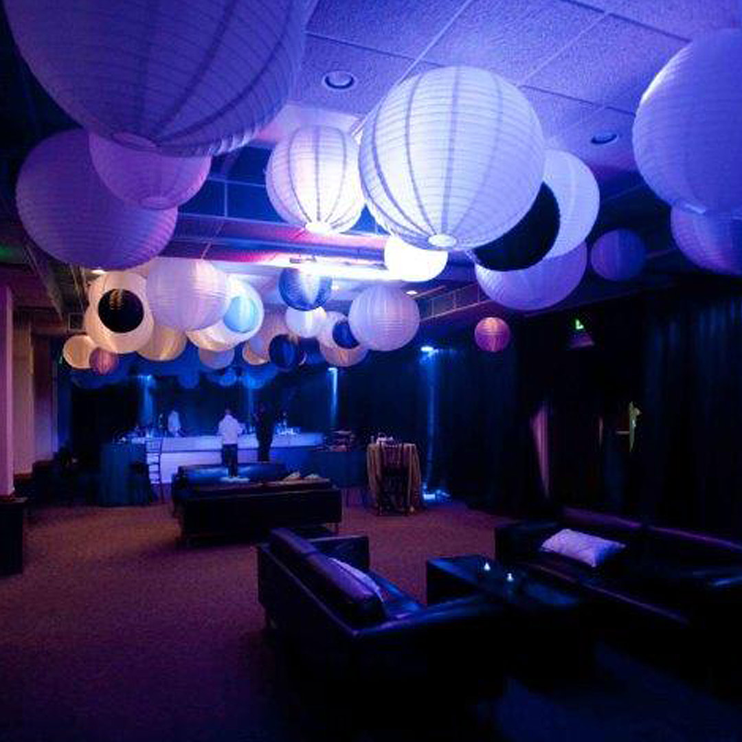 Blue lighting and elegant wedding decor with a cozy lounge area