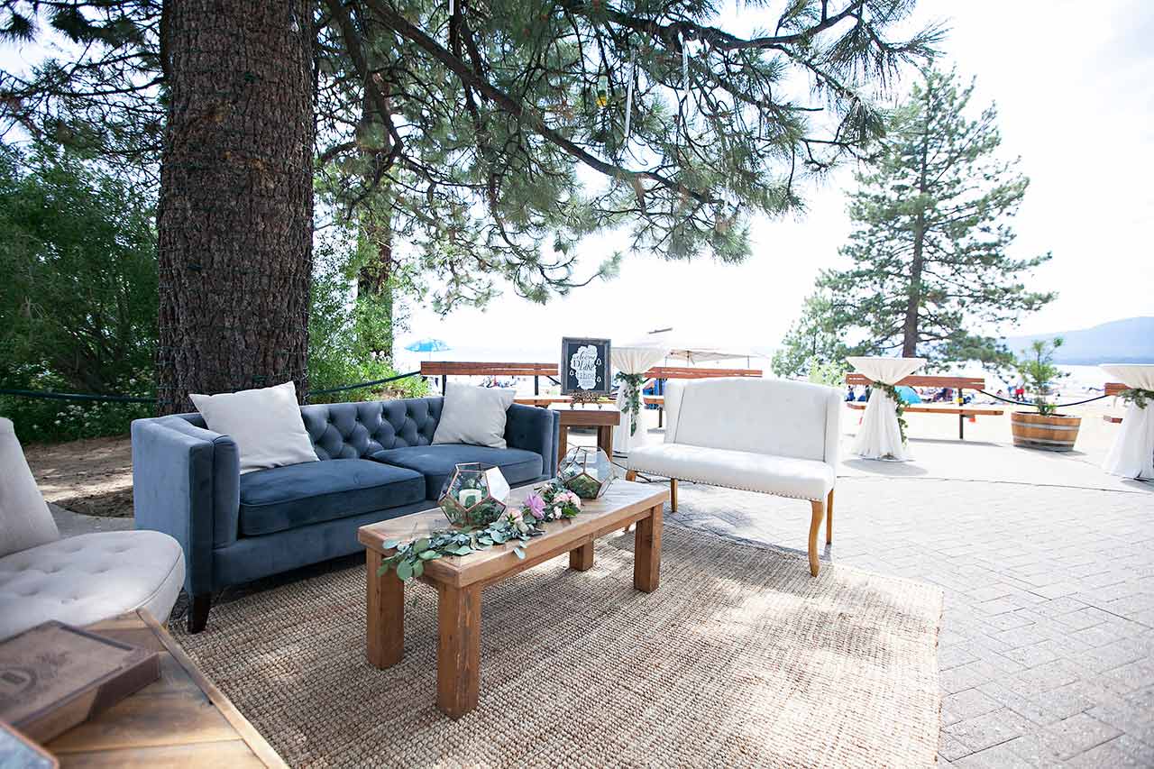 Comfortable seating area beneath a pine tree with Lake Tahoe in the background